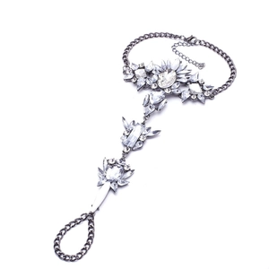 Macro detail of rhinestone bohemian slave bracelet with dark grey metal and floral patterns