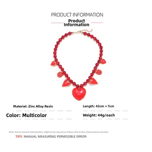 Detail of red beaded necklace with heart and rose pendants, 43cm length plus 7cm extender