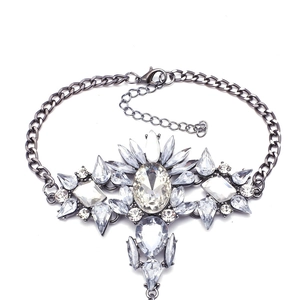 Detailed macro view of rhinestone cluster pendant on a gunmetal beach anklet chain