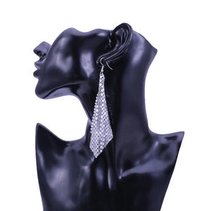 Detail of silver metallic sequin tassel earrings on a black mannequin bust