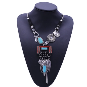 Bohemian vintage long necklace with blue turquoise and feather pendants on mannequin