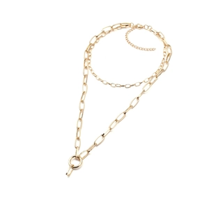 Detail of gold double-layered necklace featuring a mix of fine and thick chunky chain links