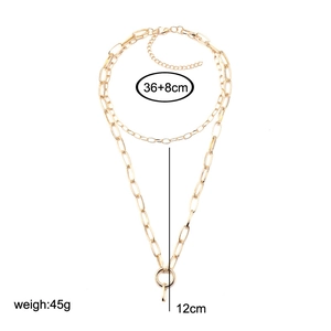 Double-layered gold chain necklace with thick links and minimalist ring pendant