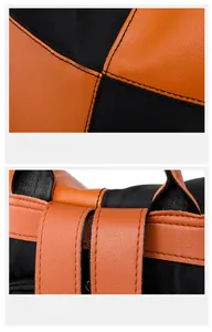 Detail of orange lychee leather and black nylon contrast stitching on a backpack