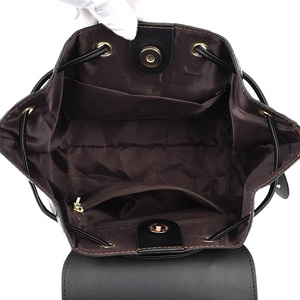Quilted black leather backpack with drawstring closure and spacious inner compartment