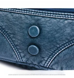 Detail shot of vintage blue washed leather bag showing metal rivets and V-shaped stitching