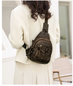 Detail showing the adjustable bronze buckle and vintage PU leather texture of the crossbody bag