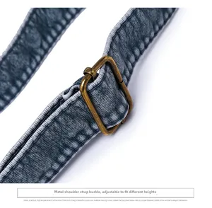 Detail of adjustable strap with bronze metal buckle on vintage washed leather handbag