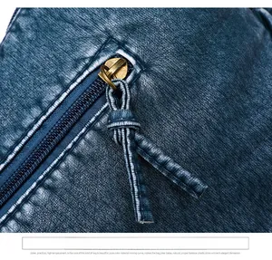 Close-up of golden metal zipper with leather puller on dark blue vintage bag