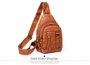 Side view of brown retro washed leather chest bag with functional zipper compartments