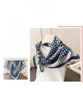 Detail of navy blue and beige triangle pattern scarf with silk texture and rolled edges
