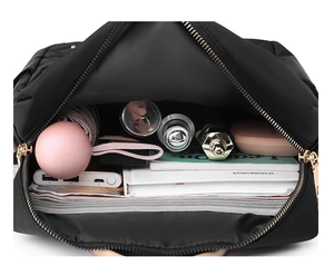Top view showing the large capacity and interior storage space of the black nylon backpack