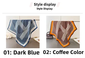 Detail of geometric pattern square scarves in navy blue and brown hanging on a metal rod
