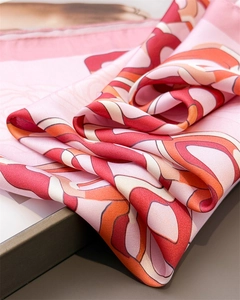 Detailed view of elegant floral print silk-like scarf with soft lustrous texture