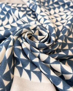 Macro shot of soft cotton linen shawl with blue and white geometric star patterns