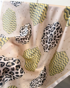 Close-up of leopard and wave print satin scarf showing smooth texture and folds