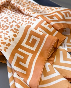 Macro view showing leopard print pattern and Greek fret border on satin polyester scarf