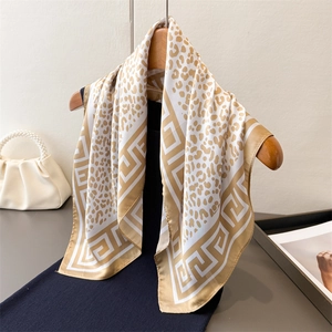 Elegant leopard print silk scarf in champagne gold with Greek key pattern borders