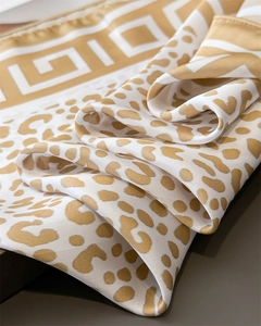Macro shot of Leopard print faux silk square scarf with geometric Greek key border