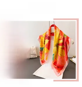 Detailed view of vibrant sunflower print on elegant silk scarf for professional women