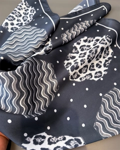 Close-up of leopard and polka dot print on silky square scarf with soft fabric folds