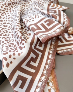 Detail of silk-like leopard print scarf with brown geometric Greek Key border