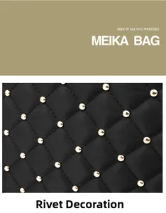 Detail of black quilted fabric with gold rivet studs and smooth stitching texture
