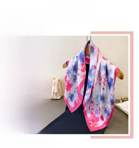 Detail of floral silk scarf with pink and blue flower patterns and rose pink hem edges