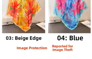 Detailed view of floral silk scarves in orange and blue with elegant rolled edges