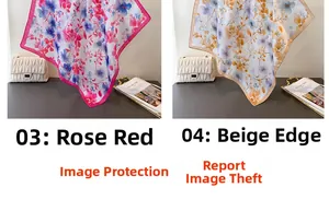 Detailed view of floral silk scarves showing satin texture and fine edge stitching