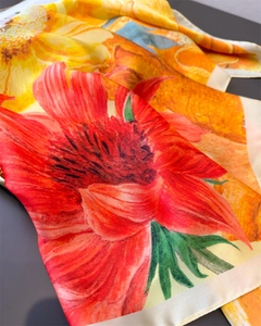 Close-up of artistic silk scarf with sunflower print and vibrant oil painting texture