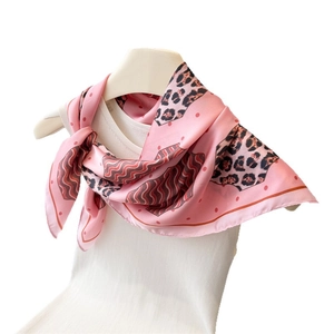 Pink leopard print silk square scarf worn on a white mannequin for an elegant look