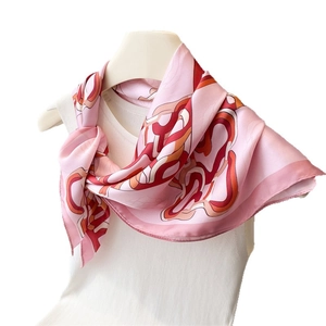 Elegant cherry pink silk scarf with abstract geometric print on a white mannequin