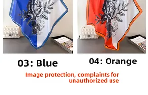 Detail of rose print silk scarves in blue and orange with elegant satin texture