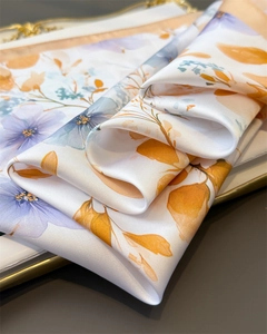Detail showing satin luster of floral silk scarf with lavender flowers and orange leaves