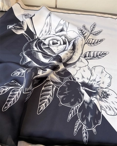 Detail shot of the elegant black and white rose pattern on smooth faux silk scarf