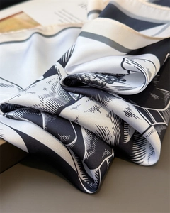 Macro shot of silk scarf showing monochrome rose pattern and smooth satin texture