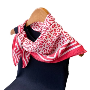 Elegant red leopard print satin silk square scarf with geometric border on a hanger