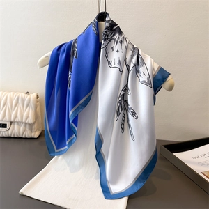 Elegant navy blue and white rose floral silk scarf displayed on a white hanger
