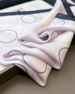 Macro view of silky square scarf with abstract circular patterns and pearly finish