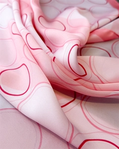Macro shot of silk scarf showing abstract circular patterns and elegant fabric texture