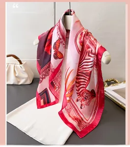 Detail of silk scarf with red butterfly and zebra patterns draped on a white garment