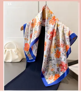 Floral print satin scarf detail on hanger with blue dress and pearl handbag