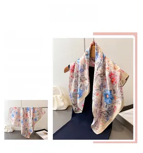 Detailed macro view of the floral print and silky texture of the vintage square scarf