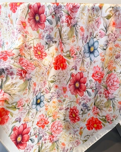 Close-up of elegant floral silk scarf with vibrant rose print and soft draped texture