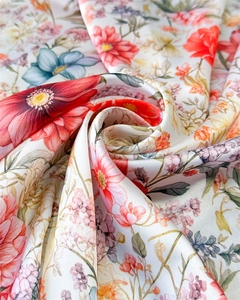 Close-up of floral print satin scarf showing silky texture and colorful flower patterns