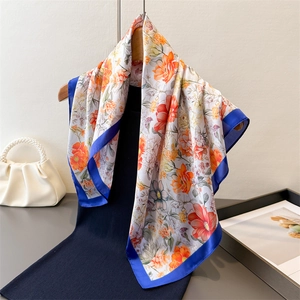 Elegant floral print silk-like square scarf for women with blue border on hanger