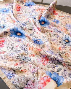 Detail of floral silk scarf showing soft fabric texture and elegant flower patterns