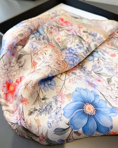 Macro detail of high-quality silk-like scarf featuring vintage blue floral print patterns
