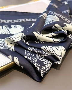 Detail of vintage navy silk scarf showing hand-drawn elephant and zebra print patterns